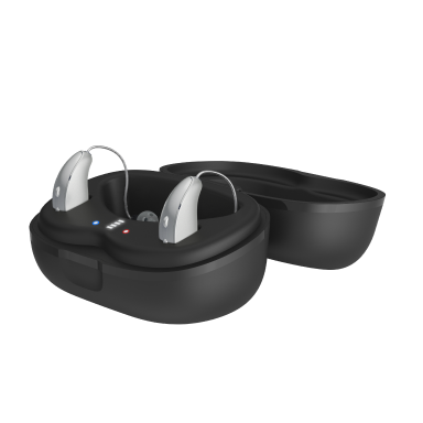 Hearing aids, one white behind-the-ear model and one black in-the-ear model, with a charging case on a blue background.