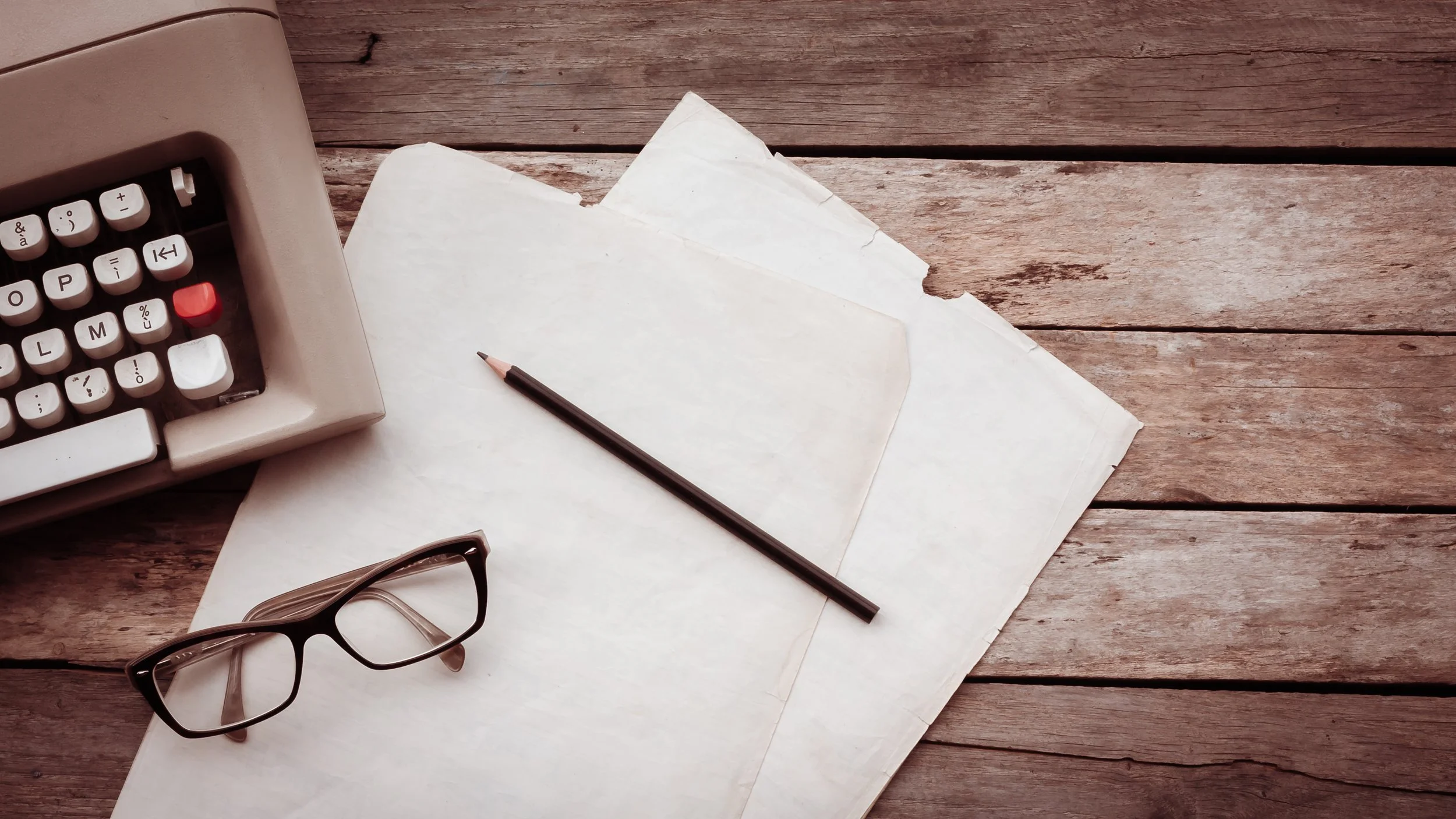 typewriter-pensil-glasses-and-paper-on-wooden-ba-2022-04-26-03-24-10-utc.jpg