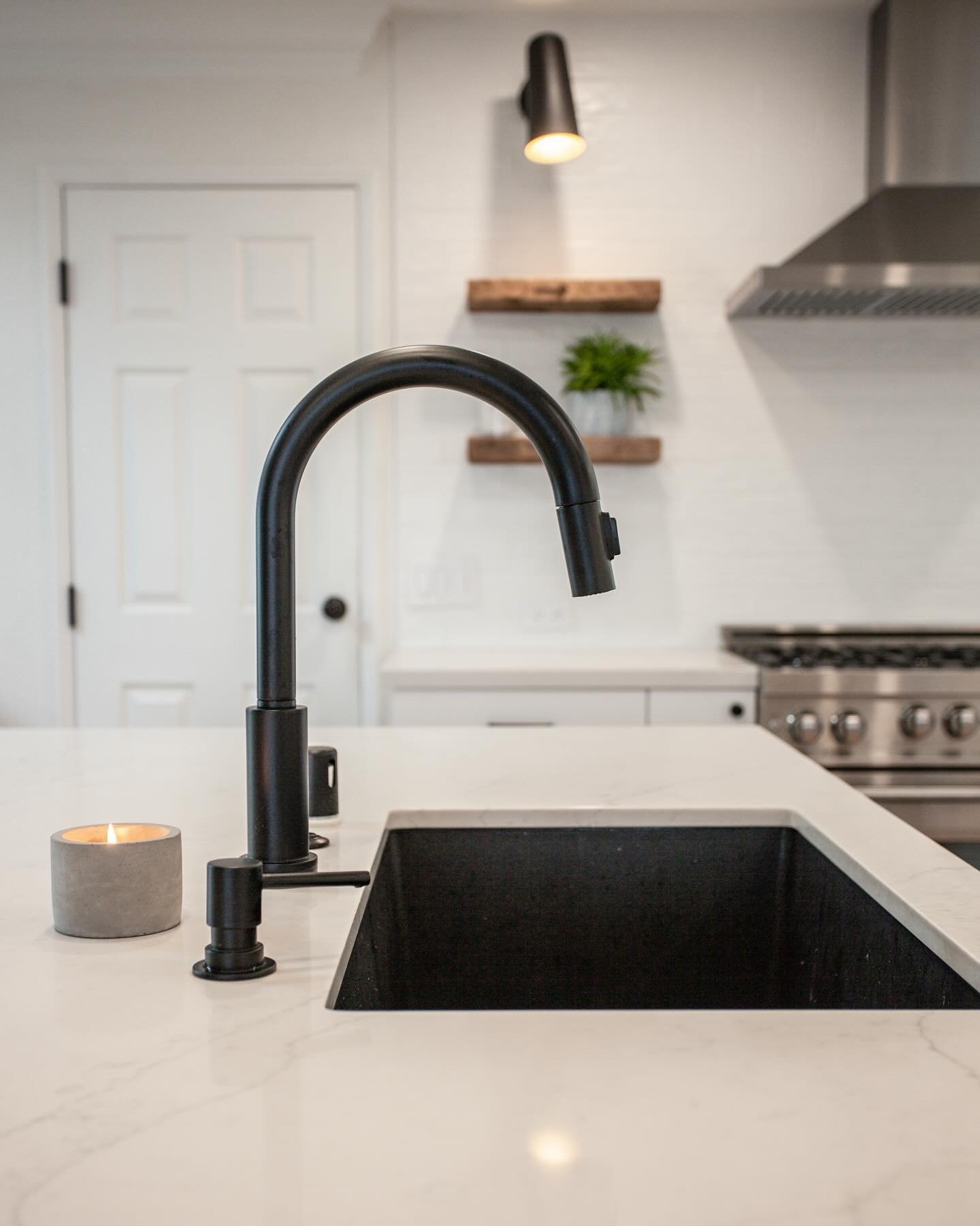This kitchen designed by Paige and Amber sports pops of black against the white cabinets and countertops. We opted for a black sink along with the black plumbing to emphasize the contrast.
