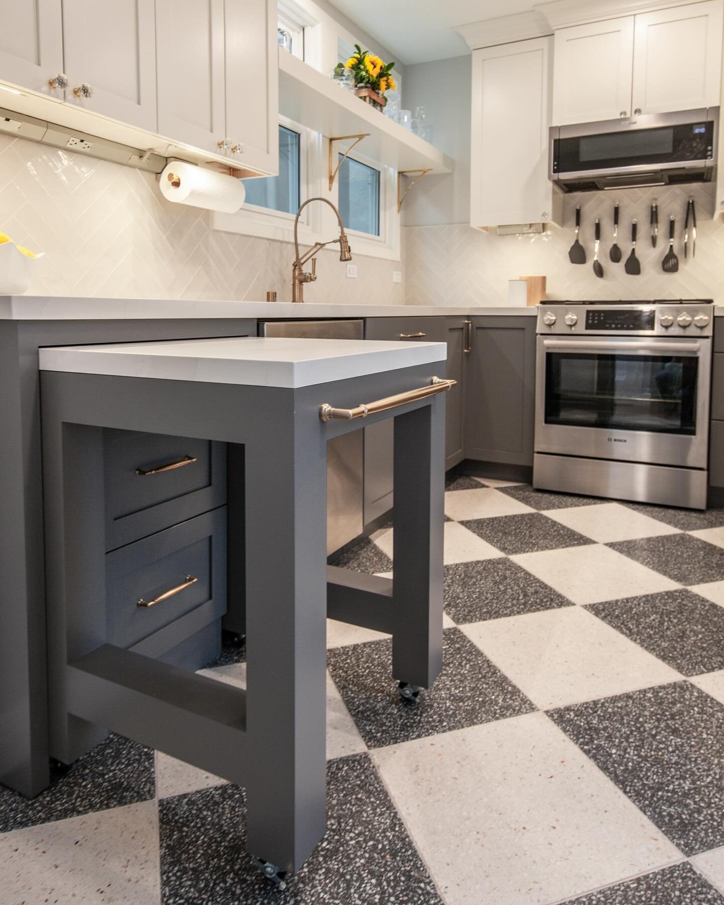 One of the coolest elements in this San Francisco kitchen is the roll-out table. It can be used for more counter space, or a spot to pull up a stool and sit. Two drawers under the table allow for a fully functional cabinet, and the large handle doubl