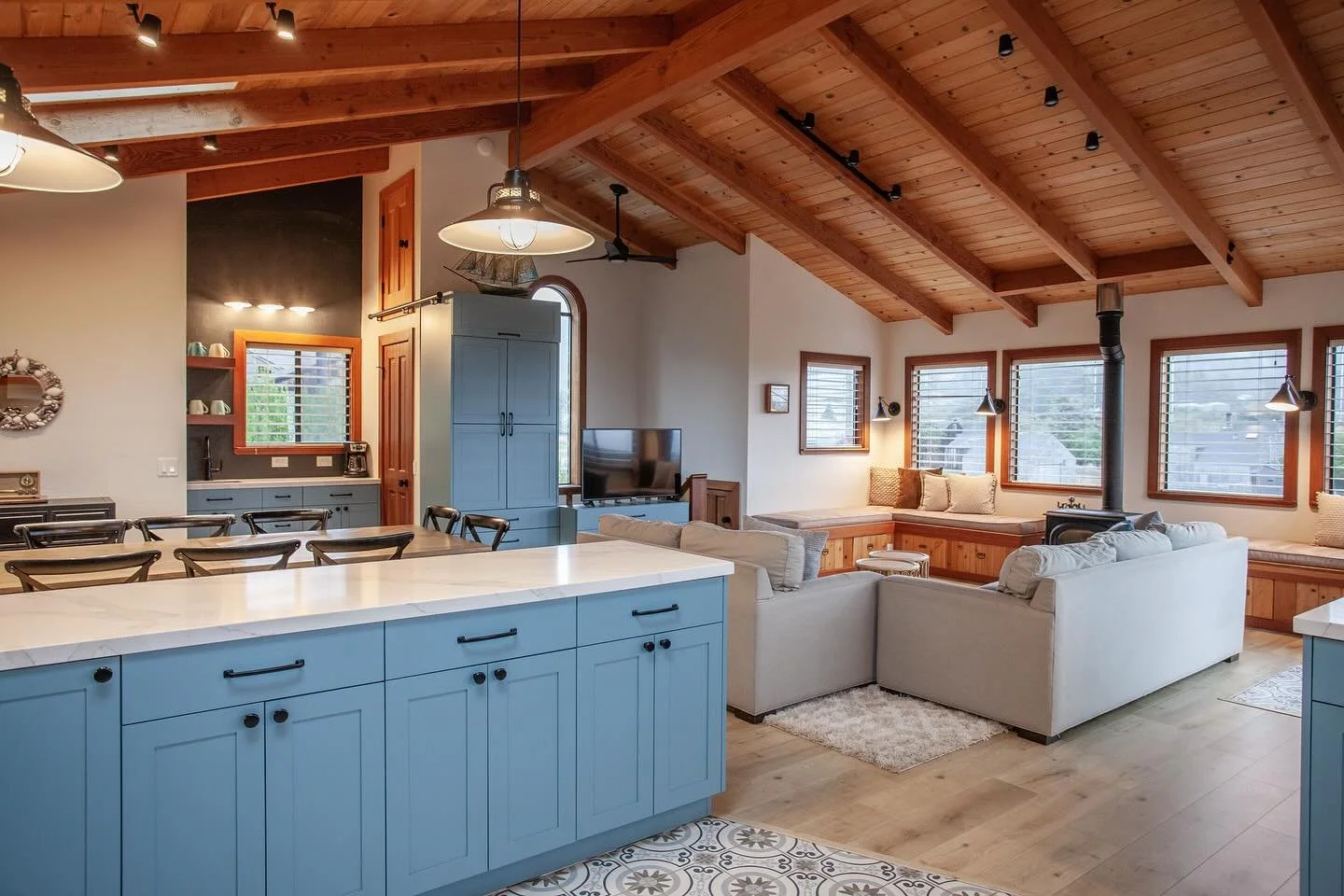 This fabulous great room is the perfect space for any seaside getaway. This home endured a full renovation top to bottom - designed by Rachael. Builder: Bettega Construction
