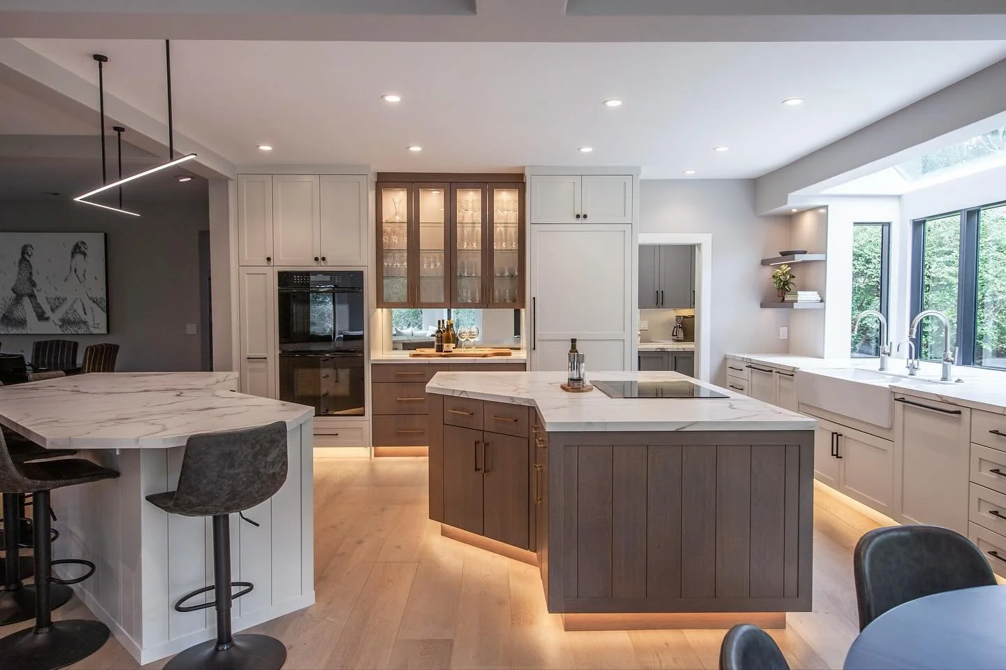 This kitchen design includes some funky island angles that provided some challenging cabinet design details. The result is a stunning modern kitchen with classic finishes and details. 
Cabinetry design: Martin
Builder: Dan Knego
Interior designer: HK
