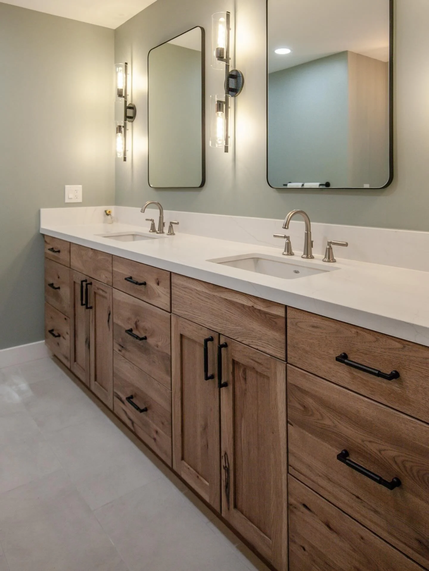 Rustic hickory really shines in this primary suite designed by Paige. Surrounded by calming neutral colors and textures, it really helps give this room a touch of zen.