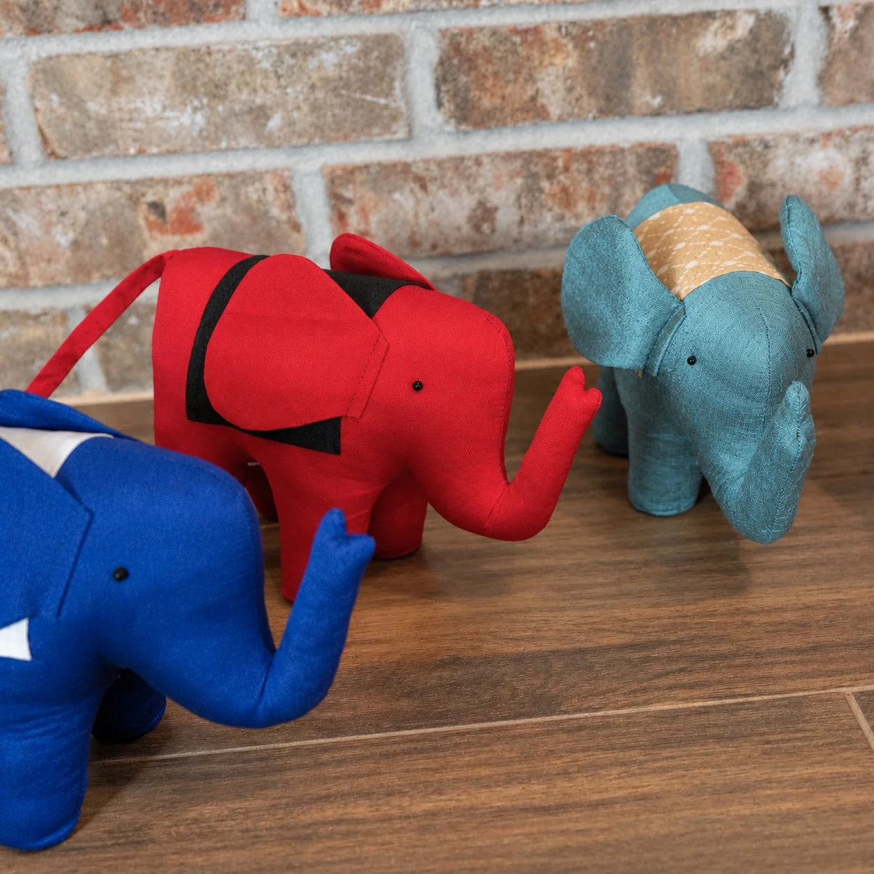 Three Stuffed Elephants on Wood.jpg