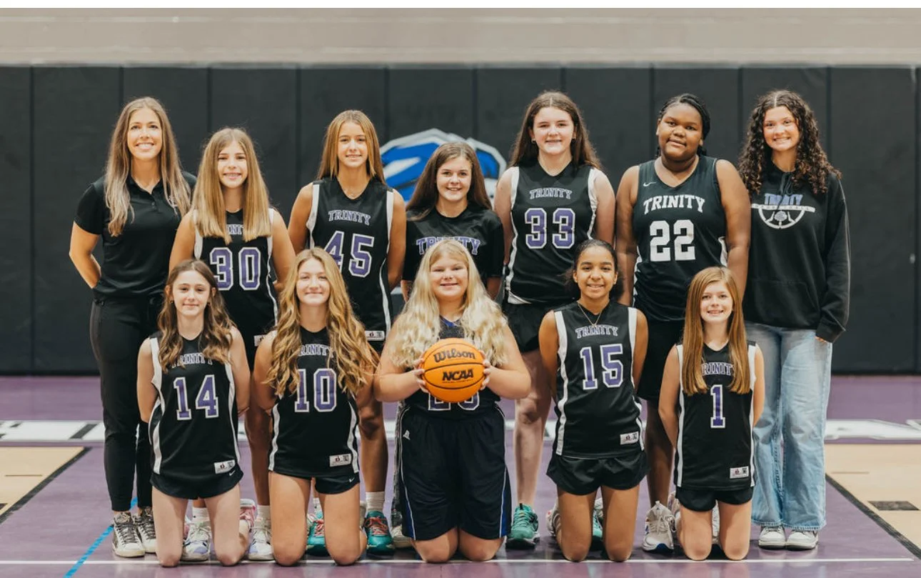 Trinity Christian School middle school girls basketball team poses for a team photo with coaches, representing team readiness and athletic participation at TCS. Photography by Kala Duffey.