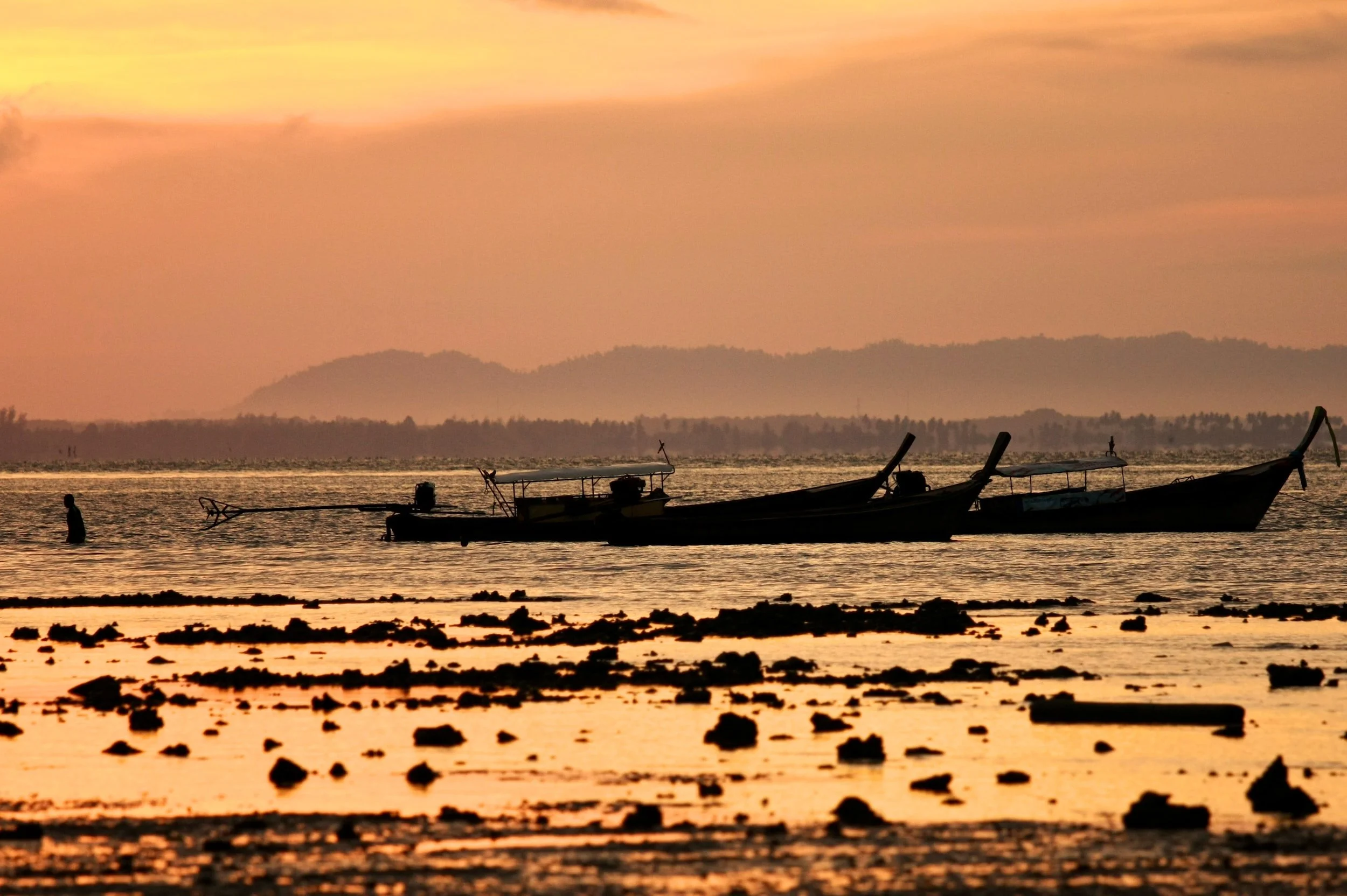 Adult Third Culture Kids experience life in far reaching places like this fishing boat at sunset in Thailand.