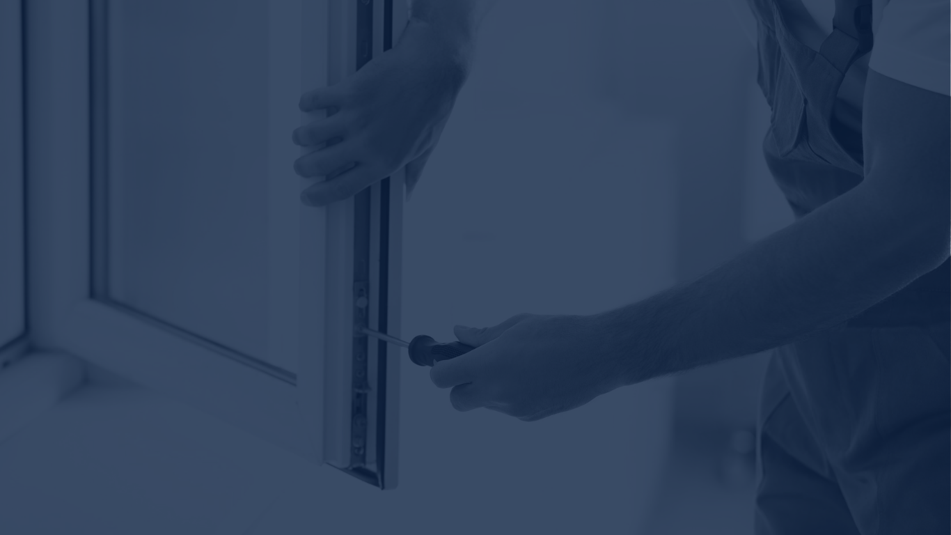 A blurry view of an engineer servicing a double glazed window.