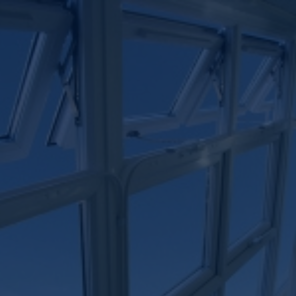 A blurry view of a server room with computer racks, monitors, and glowing indicator lights.