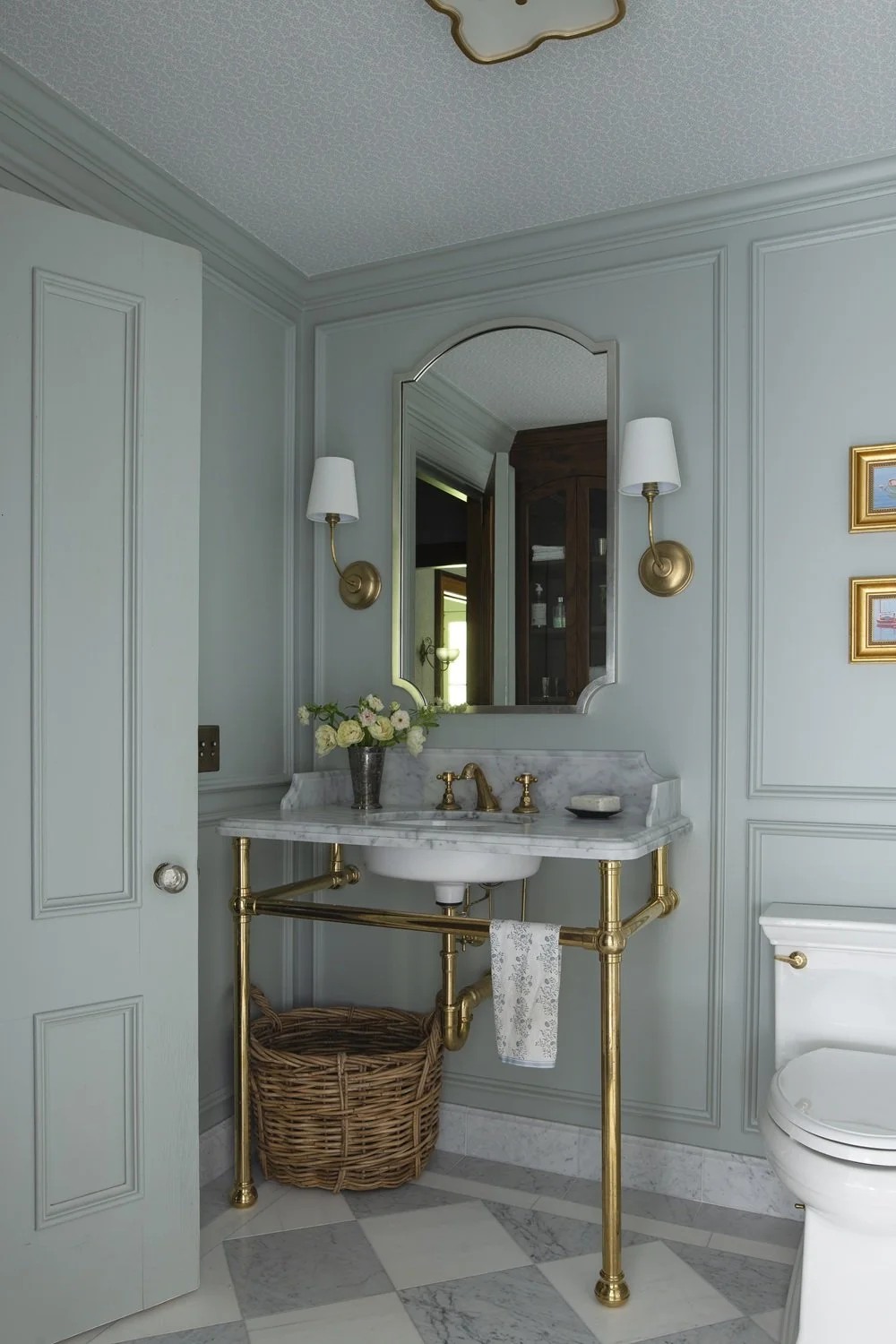 Sherborn bathroom with custom unlacquered brass vanity and marble countertop, paneling on walls and farrow and ball light blue paint