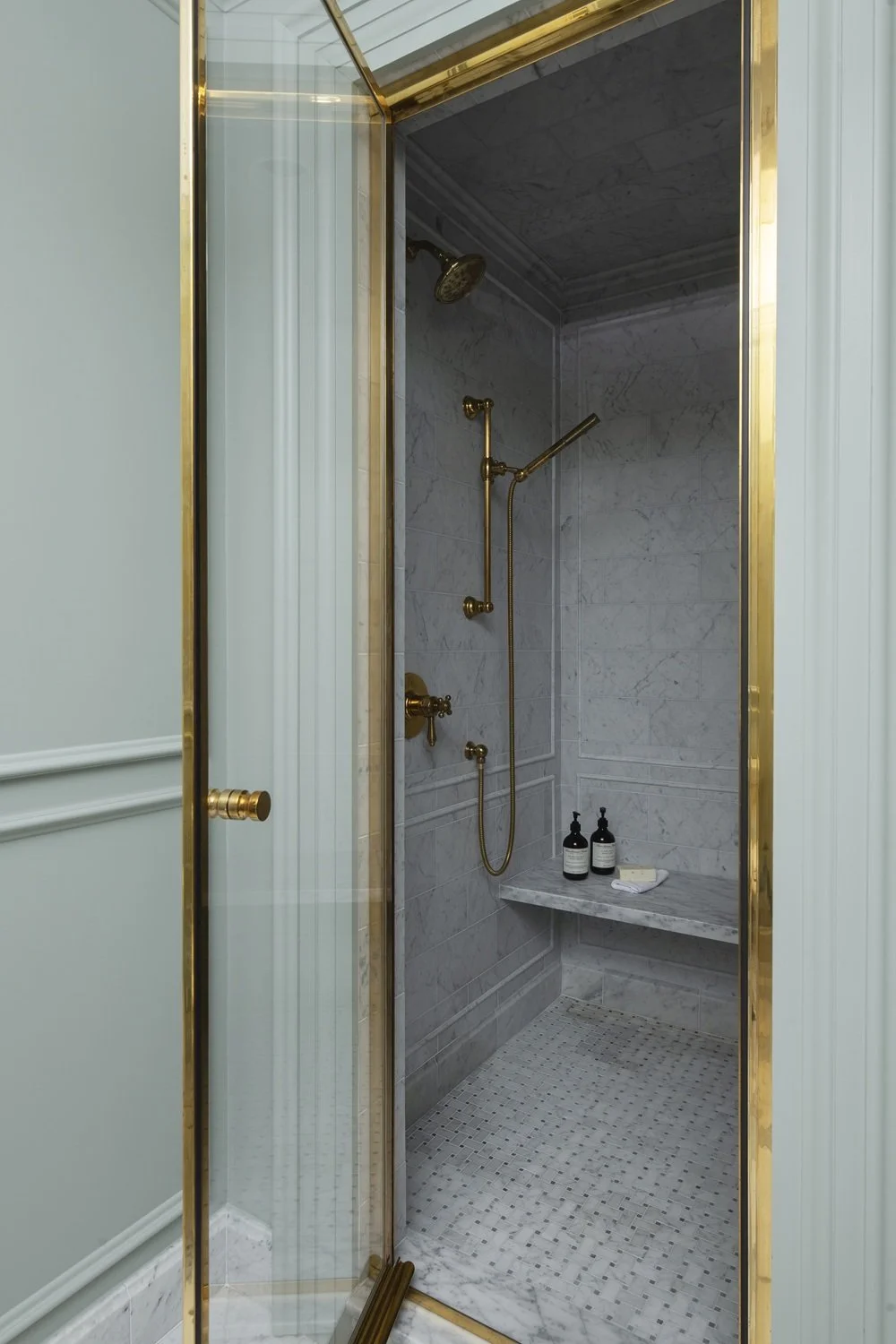 Sherborn bathroom with custom unlacquered brass shower door and marble shower interior