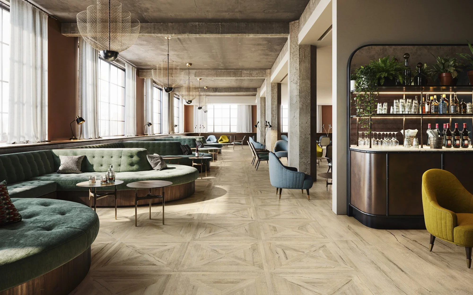 Porcelanato efecto madera Ricordi en lounge con piso tipo parquet y sillones verdes
