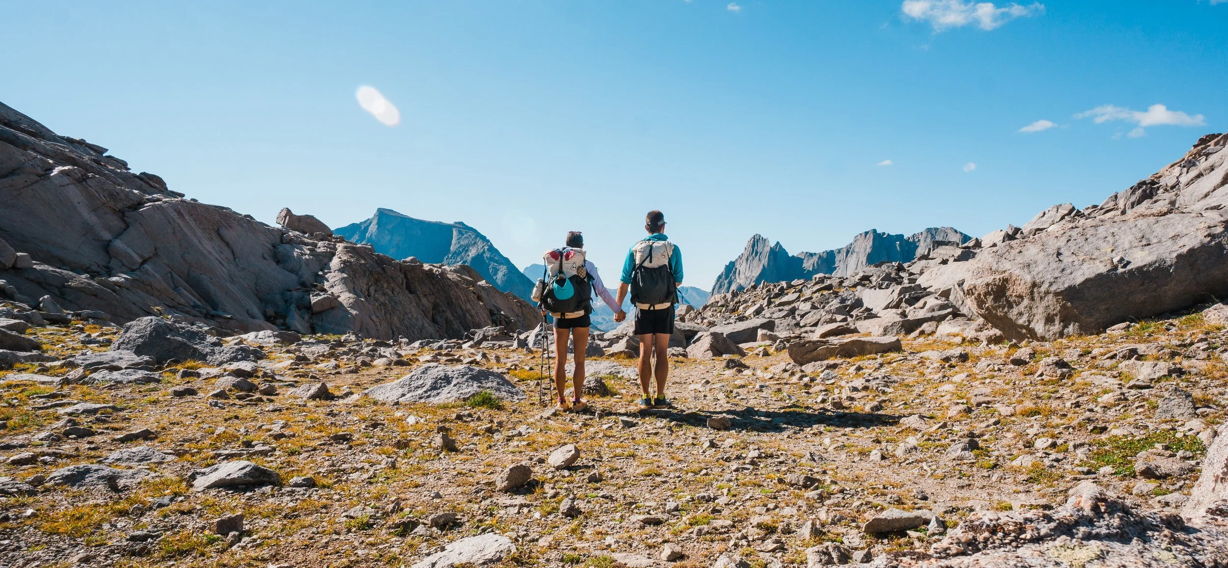 a couple holding hands a top texas pass in wind river range wyoming
