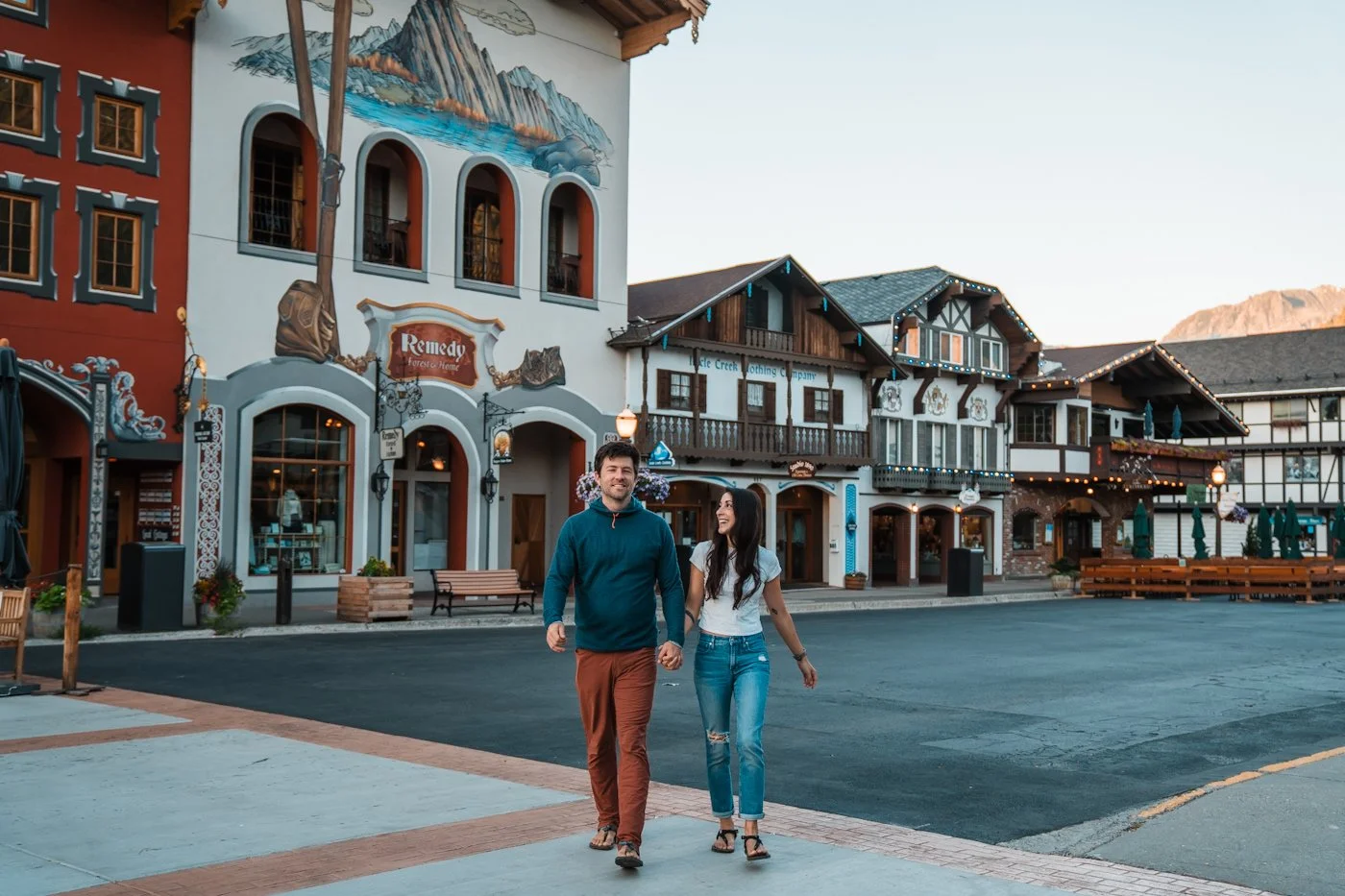 couple walking and holding hands while walking through downtown Leavenworth Washington