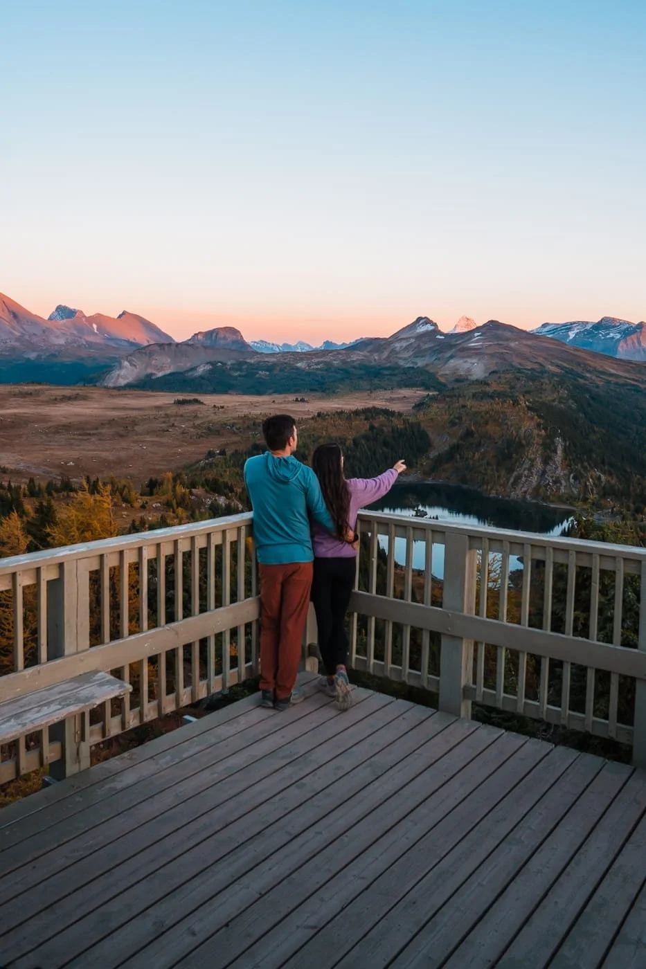Couple enjoying evening views at Standish Viewpoint at Sunshine Mountain Resort