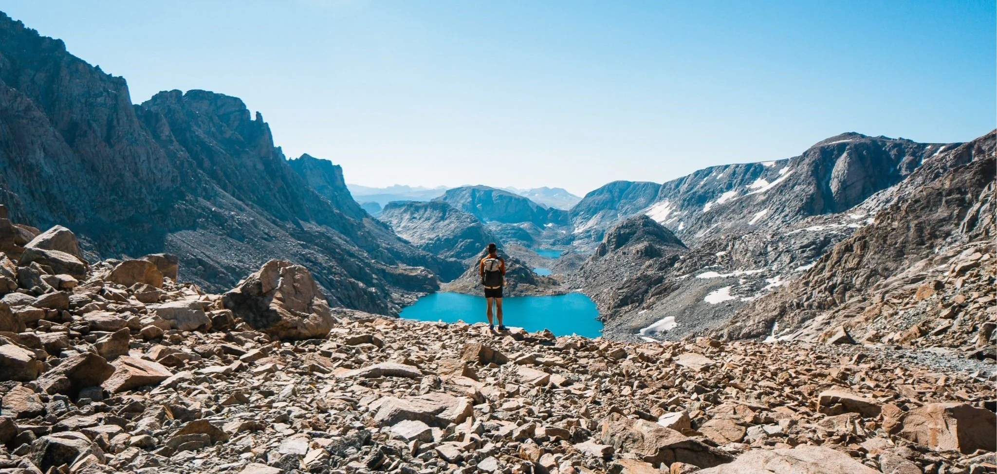 man looking down from mountain pass in wind river range wyoming