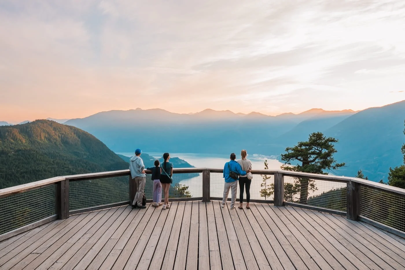 Family and couple enjoying sunset from the Sea to Sky Lodge balcony