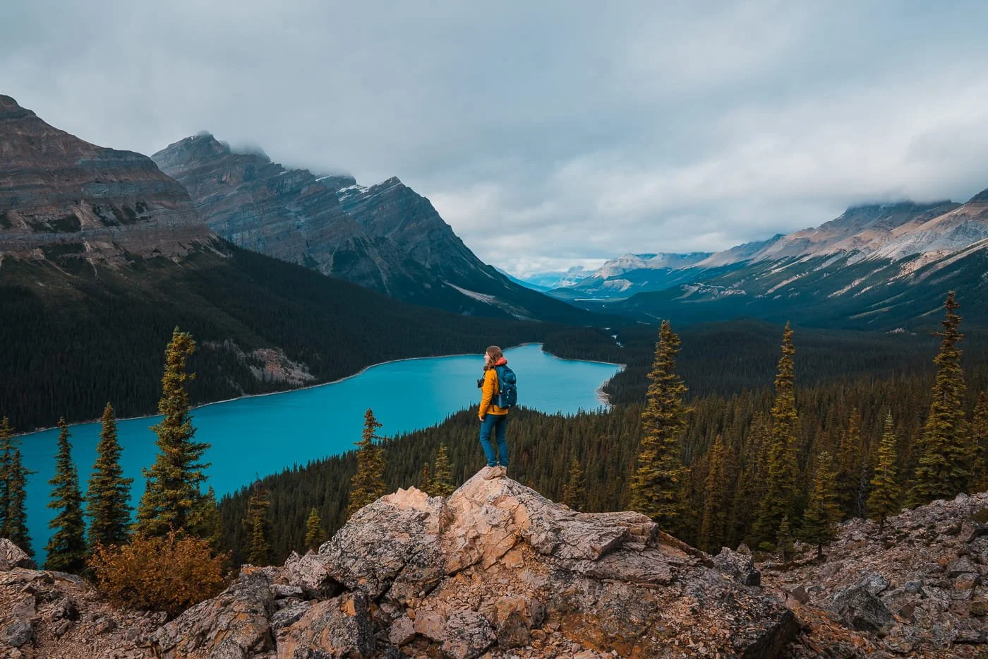 girl standing on rock outcropping above Peyto Lake in Banff National Park