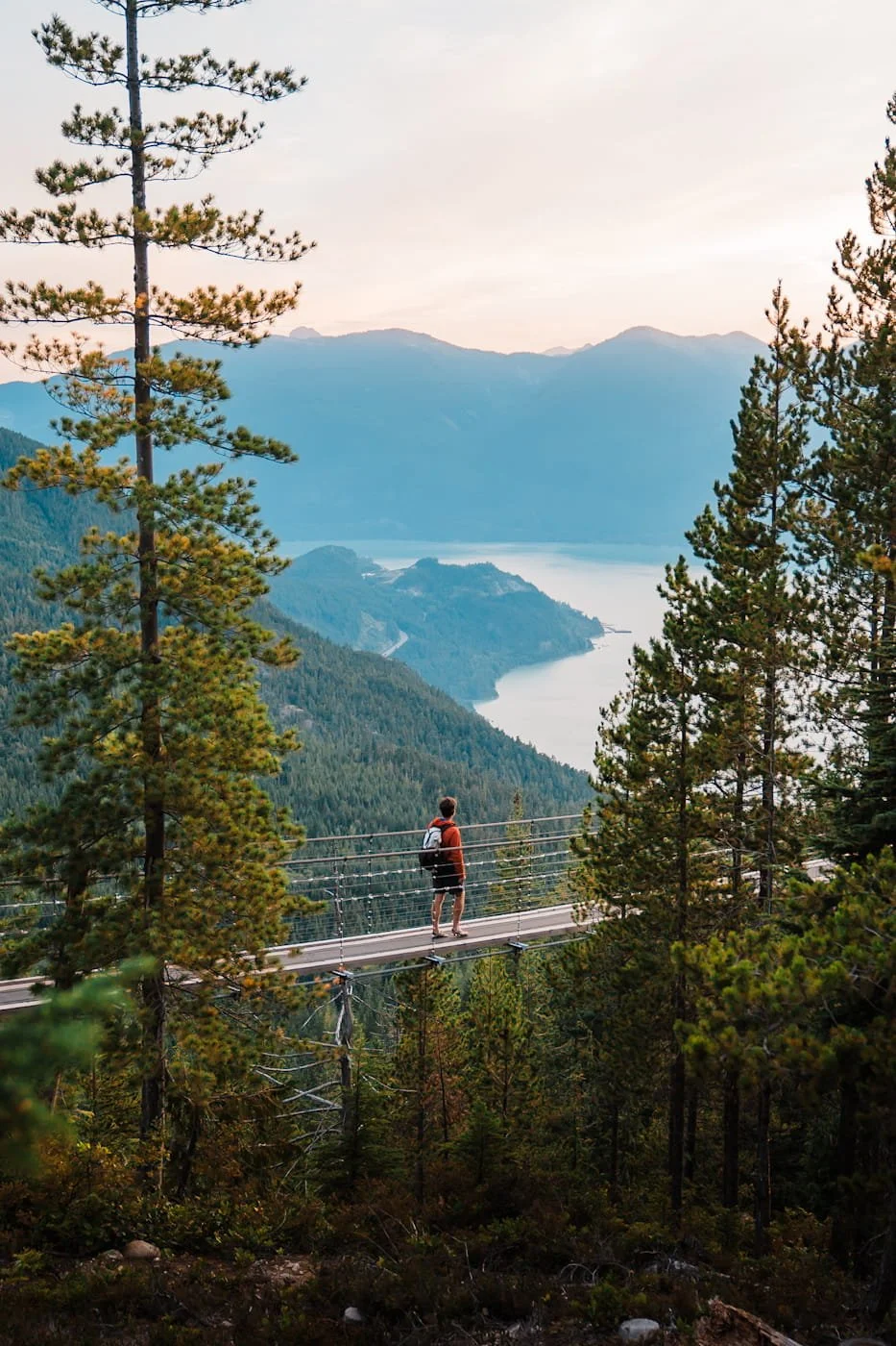 Man walking across the Sea to Sky suspension bridge