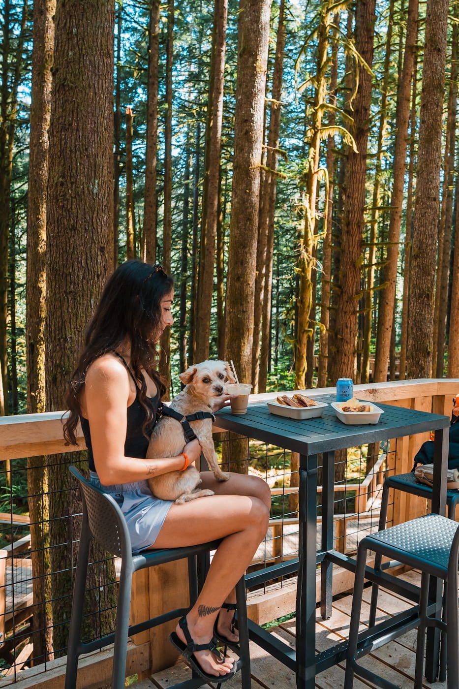 Girl and dog enjoying lunch at the Squamish Canyon cafe