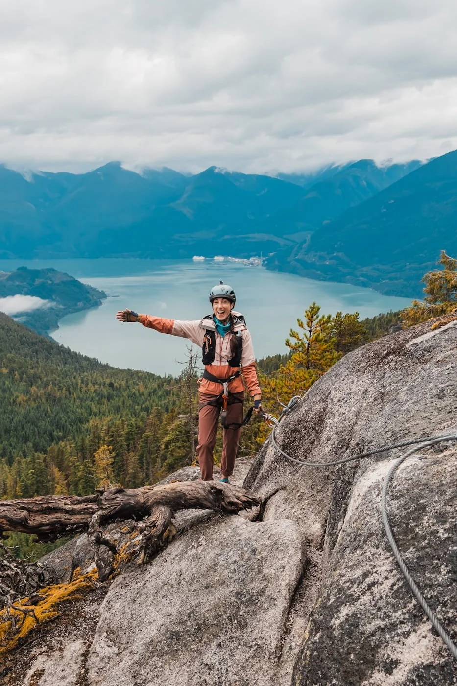 Girl walking along the steel cables on the Squamish Via Ferrata