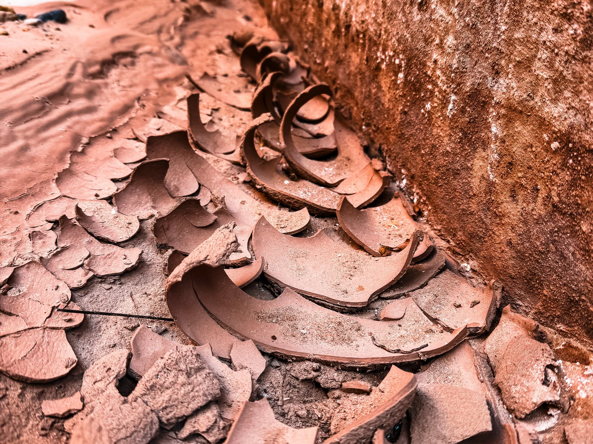 an up-close photo of dried desert mud, cracked and curling
