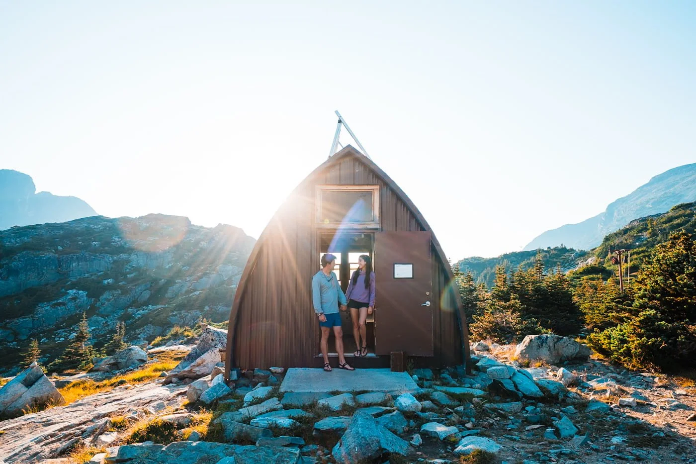 couple standing in the doorway of the wedgemount lake emergency shelter