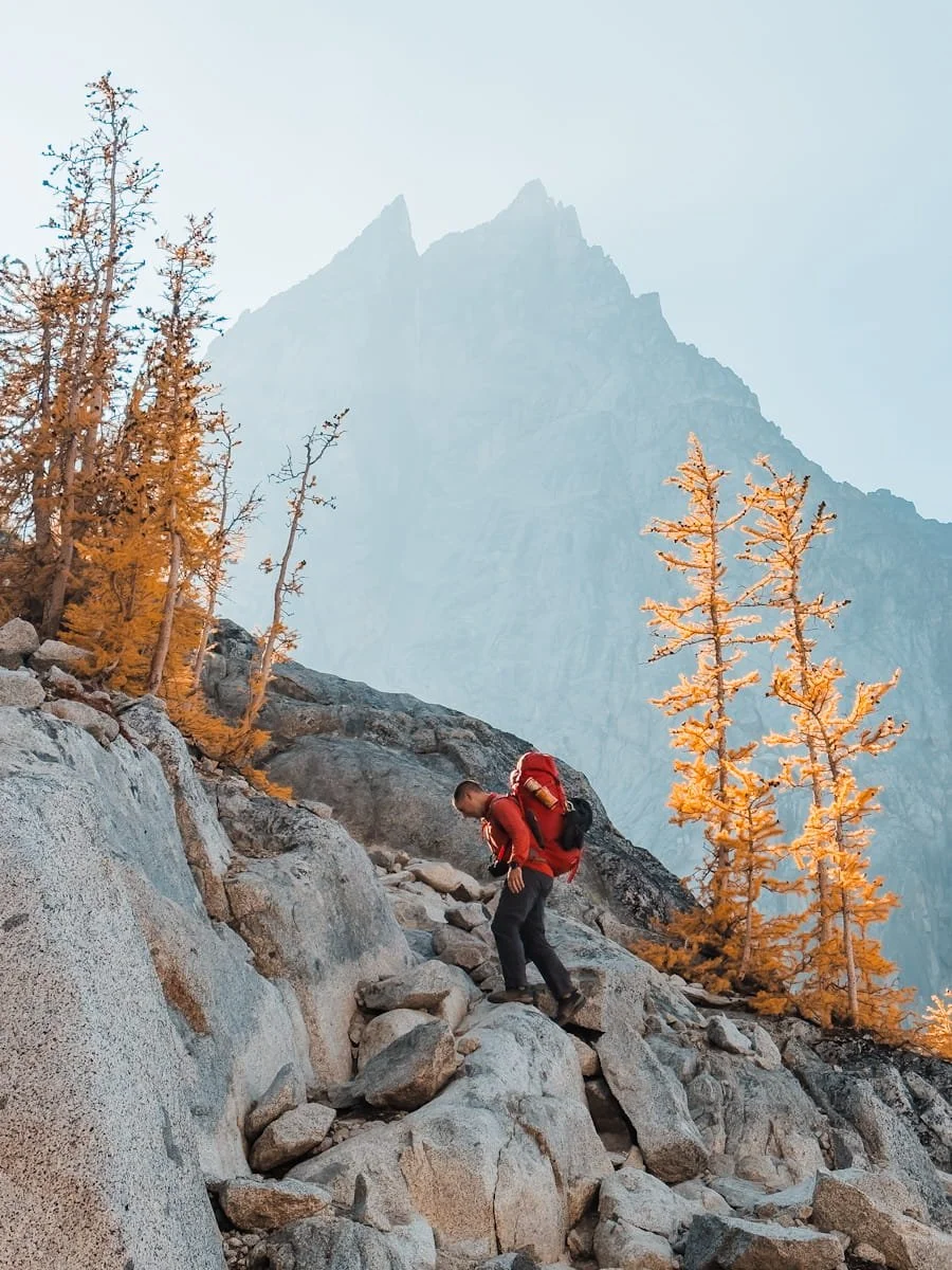  Backpacker climbing Asgard Pass with heavy pack in the Alpine Lakes Wilderness 