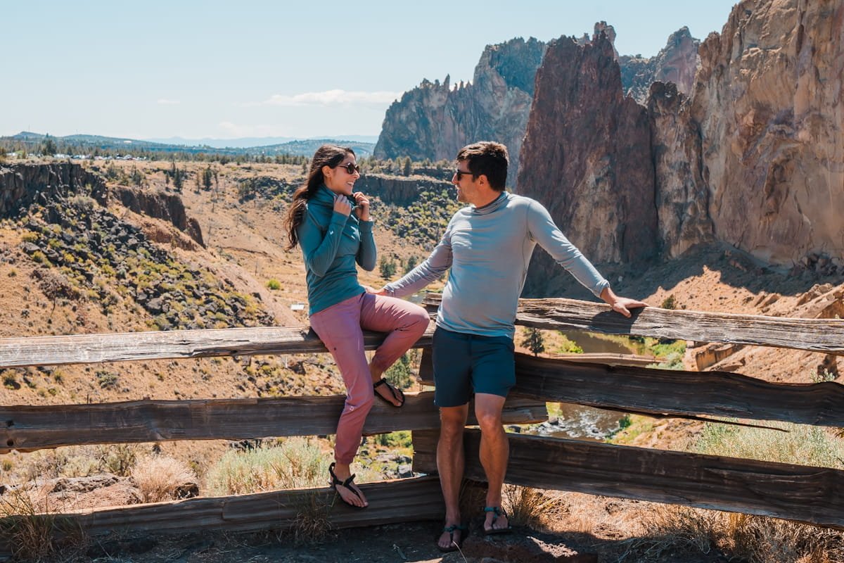 A couple wearing ridge merino pursuit ultralight hoodie at smith rock state park oregon