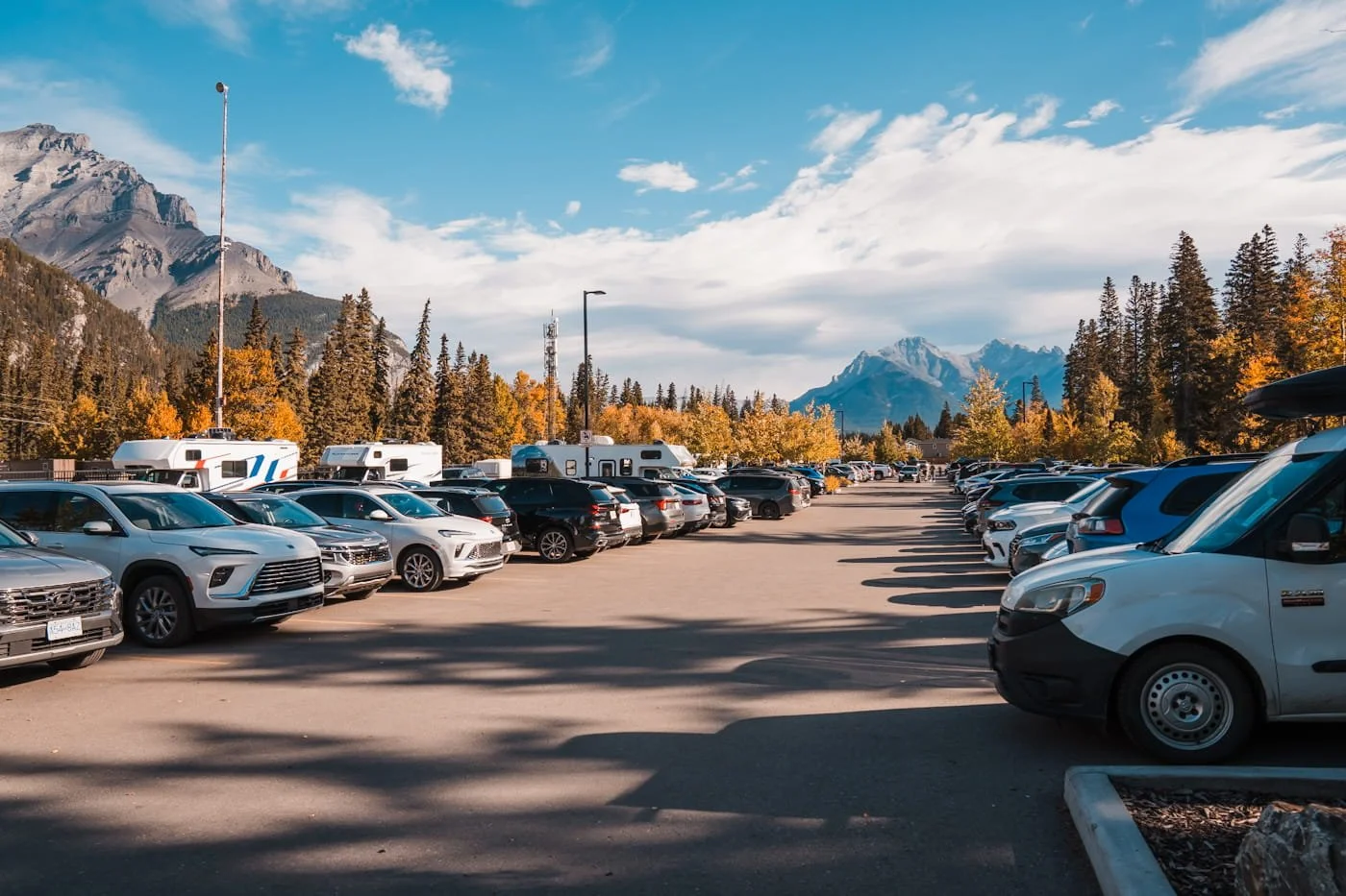 the free parking lot in downtown banff with cars parked