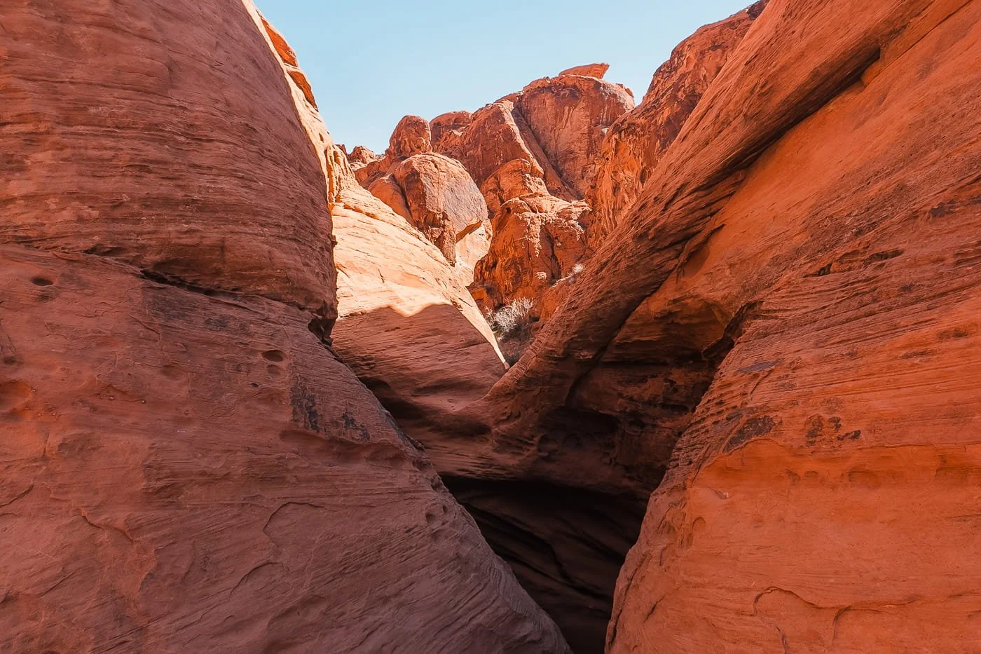 looking at sandstone rock formations through a slot canyon