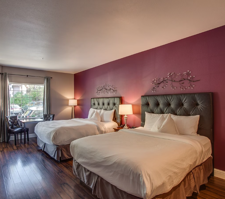 Two queen beds inside of a room in the Leavenworth Village Inn