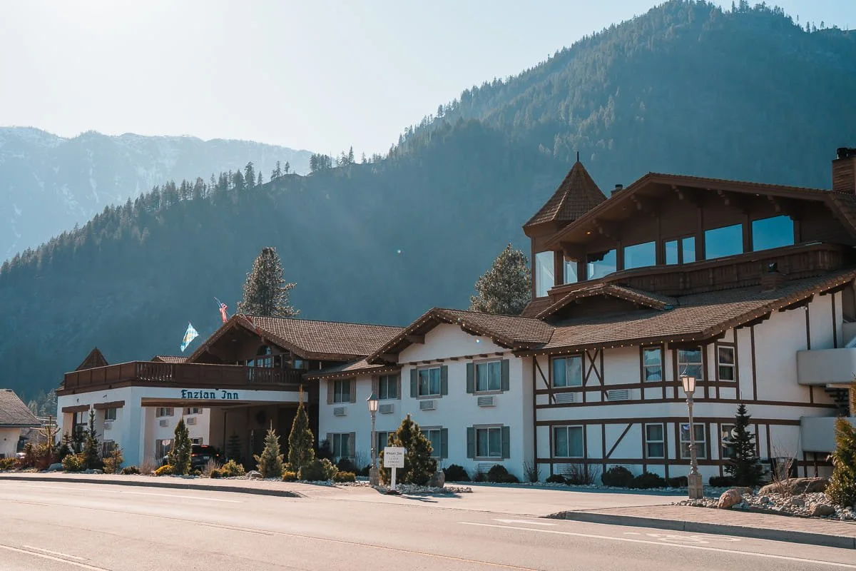 A bavarian styled hotel in leavenworth, washington with hills in the background