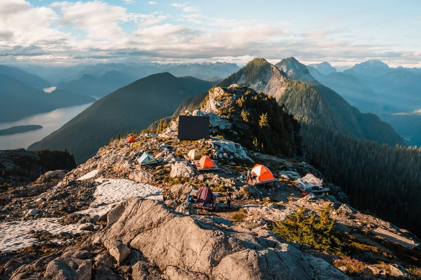 tiny tents and tent platforms along a high alpine ridge with mountains in the background at Panorama Ridge Camping area in Golden Ears Provincial Park