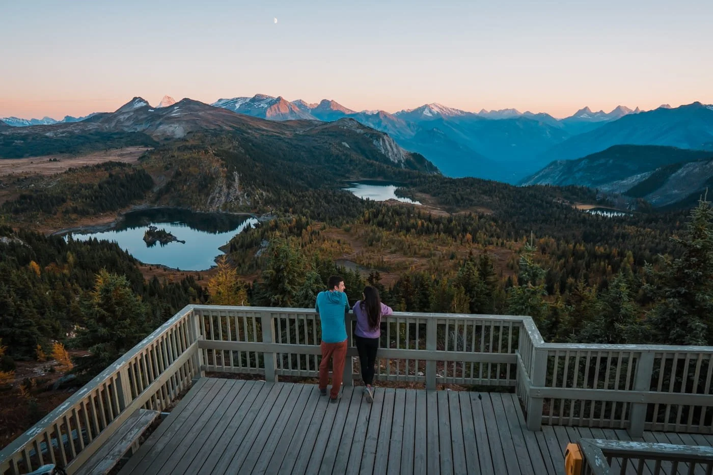 couple looking out from the standish viewpoint at Sunshine Mountain Resort