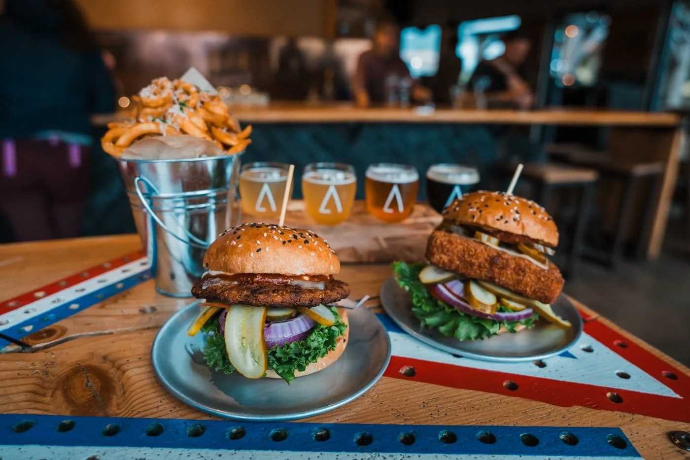 Flight of beers from A-Frame Brewery and Veggie burger and mac and cheese burgers from Flipside Burgers