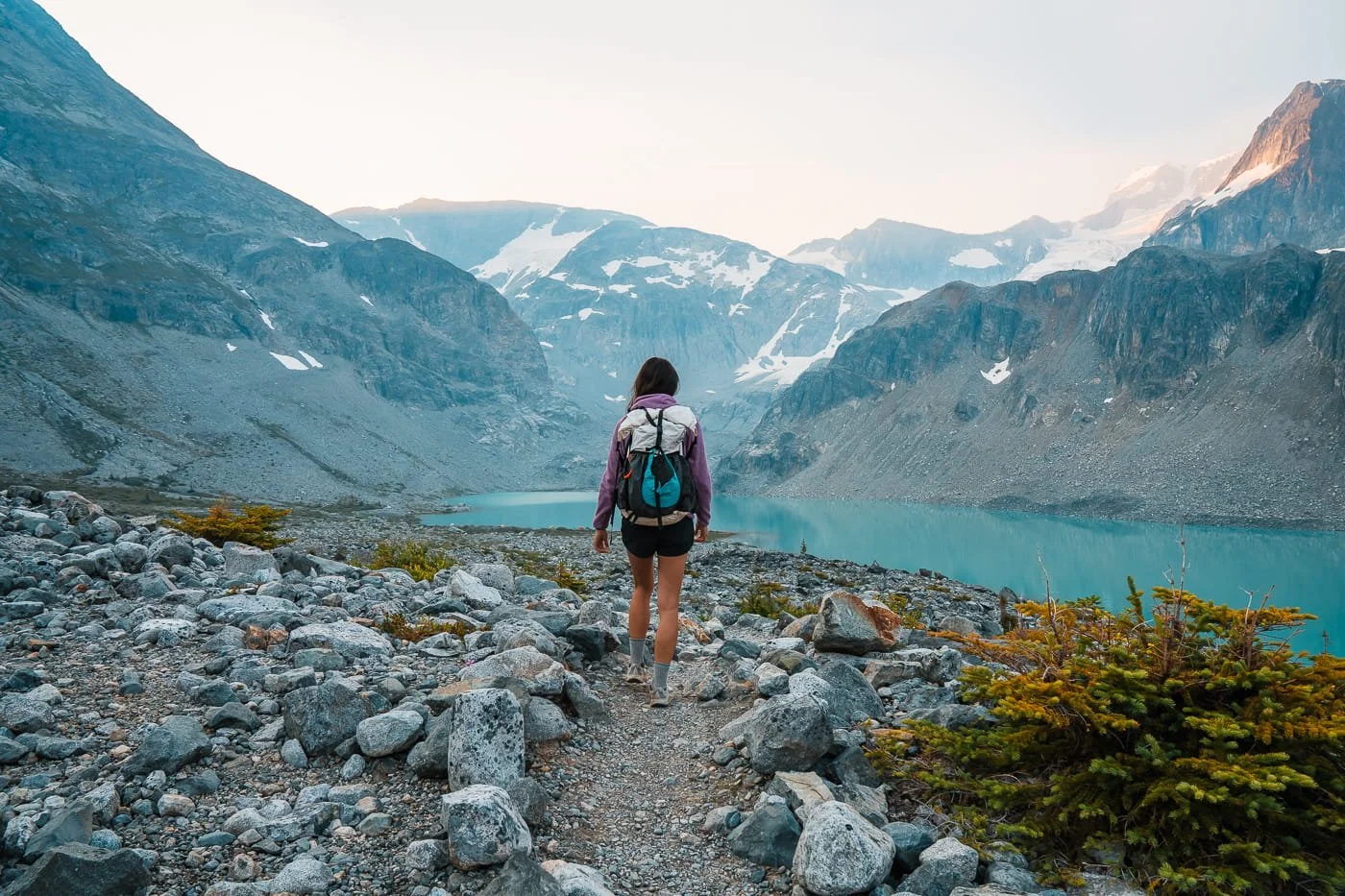 backpacker walking along the pathway between the upper and lower Wedgemount Lake camping areas