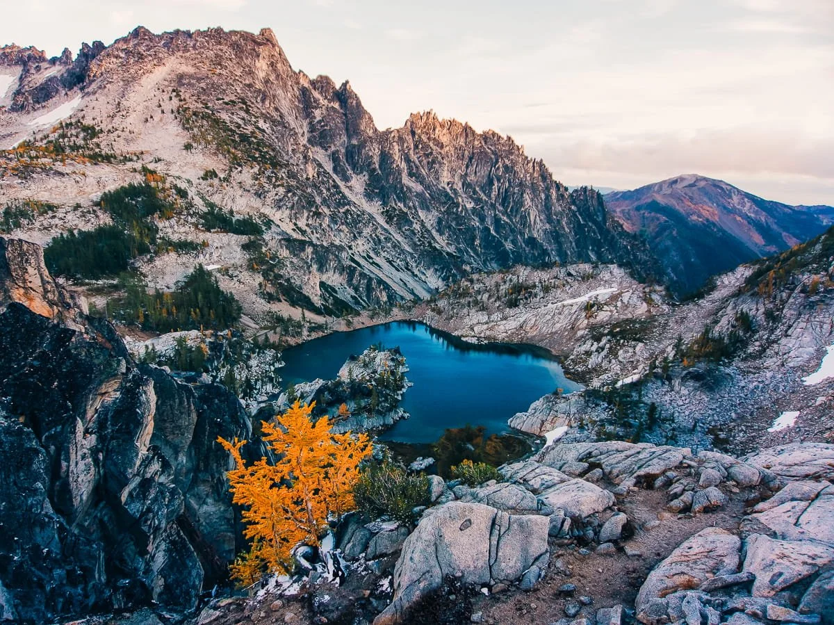 Views in the core enchantments with a bright blue lake and rocky mountains in the background