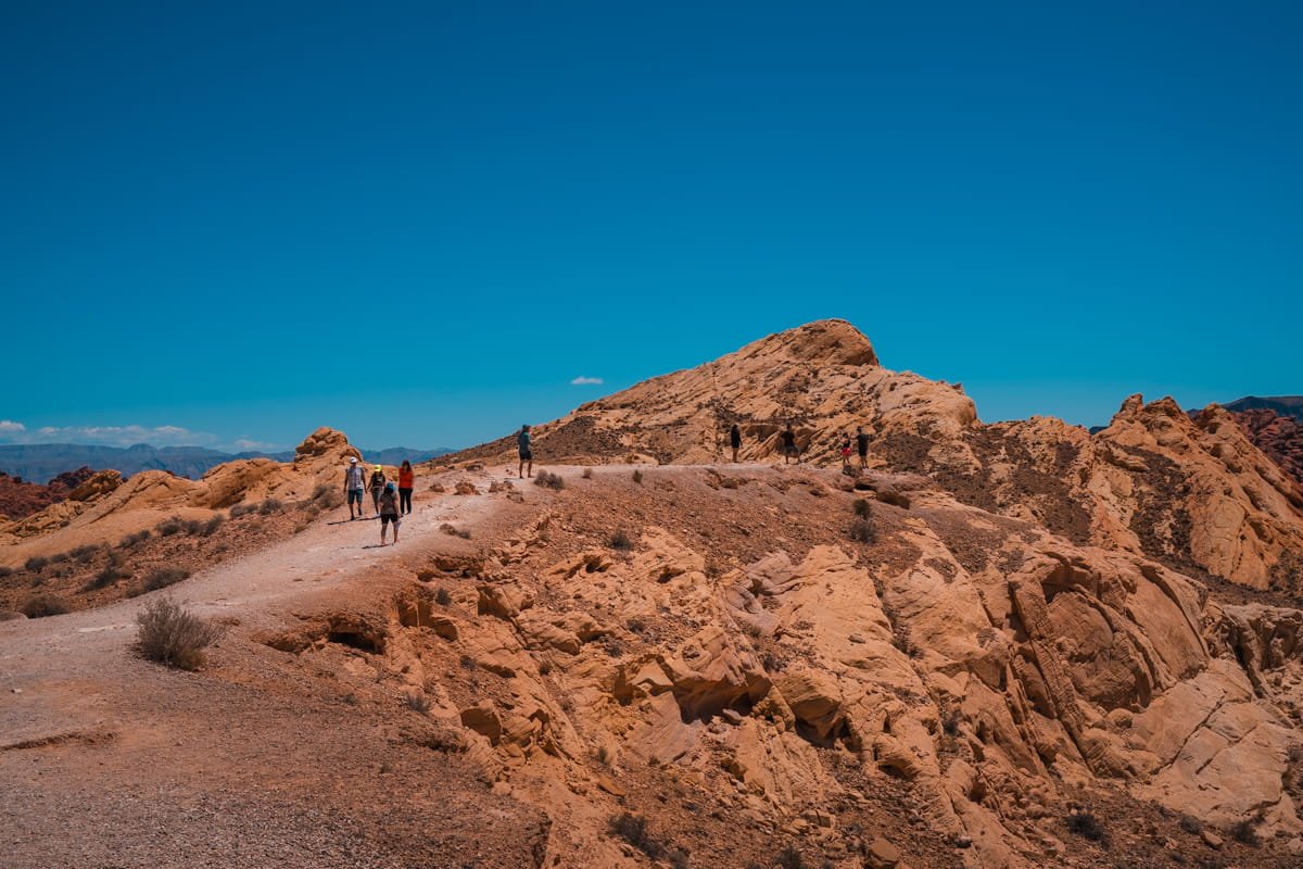 people walking up a trail to the silica dome overlook in valley of fire