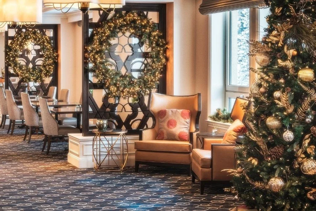one of the dining rooms at the fairmont hotel in Lake Louise, with a christmas tree and wreath