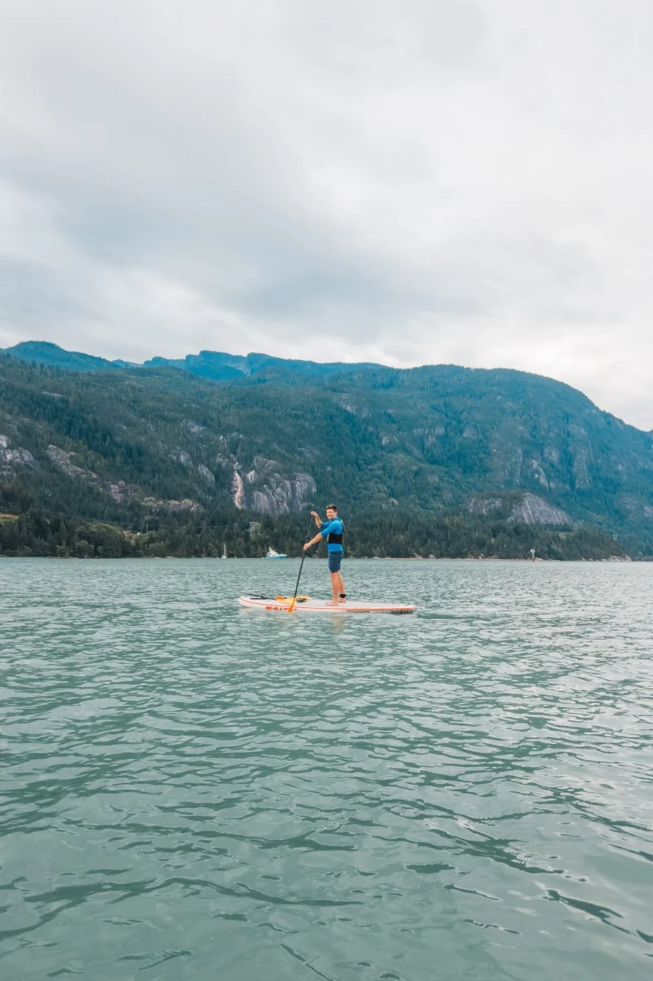 man on a stand-up paddleboard in the Howe Sound near Squamish BC