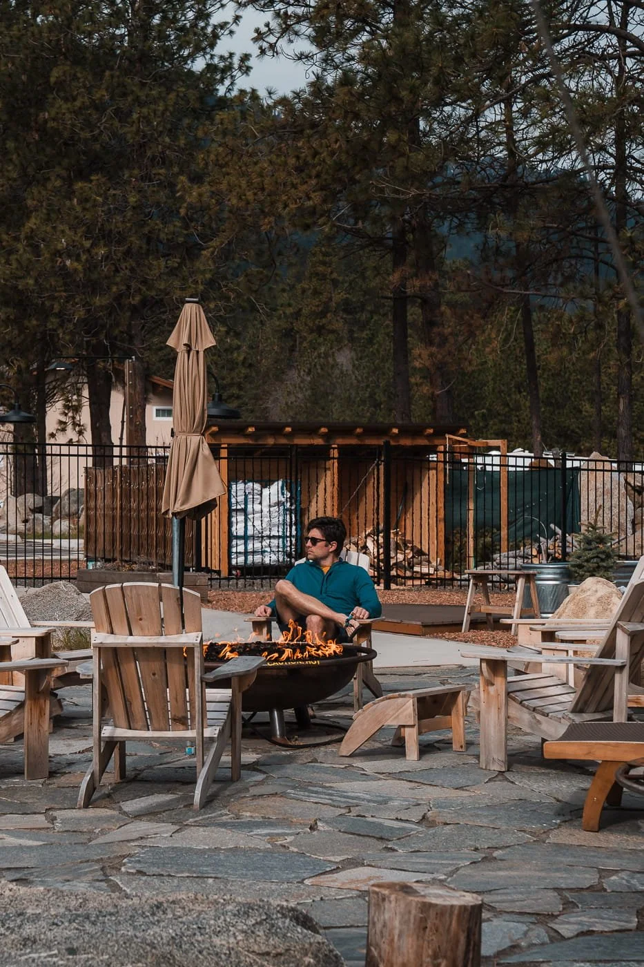Guy sitting by fire at The Springs