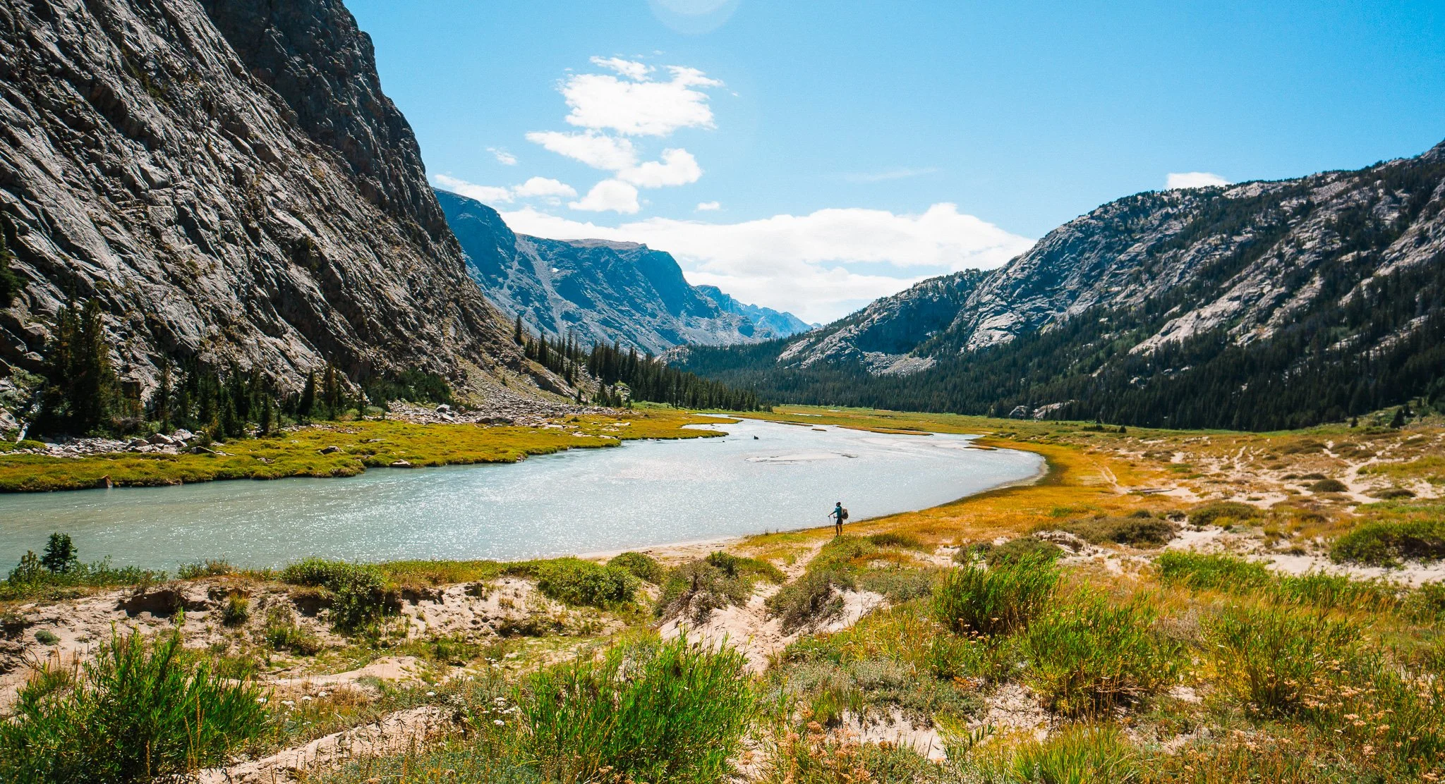 male backpacker in dinwoody creek in wind river range wyoming