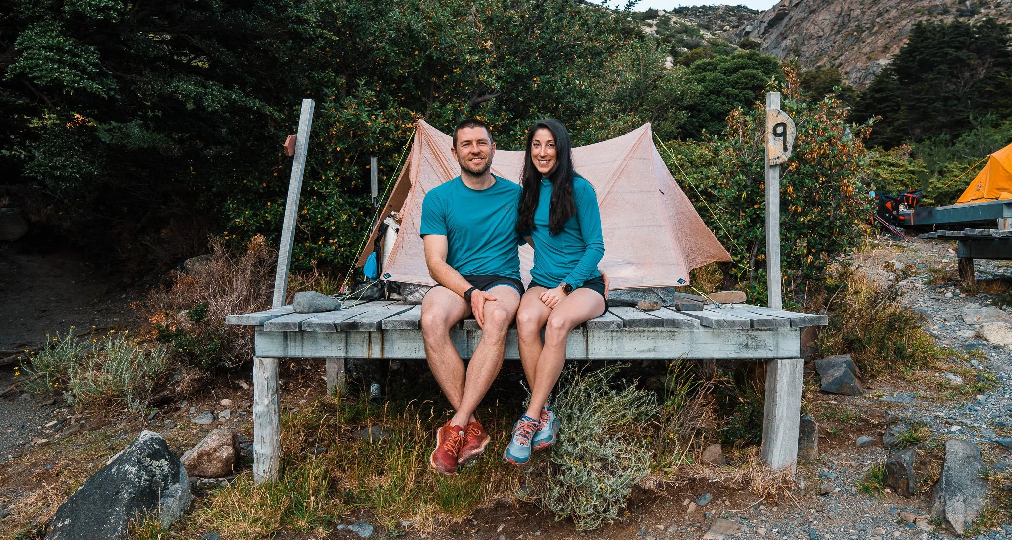 couple sitting together at camping platform at los cuernos