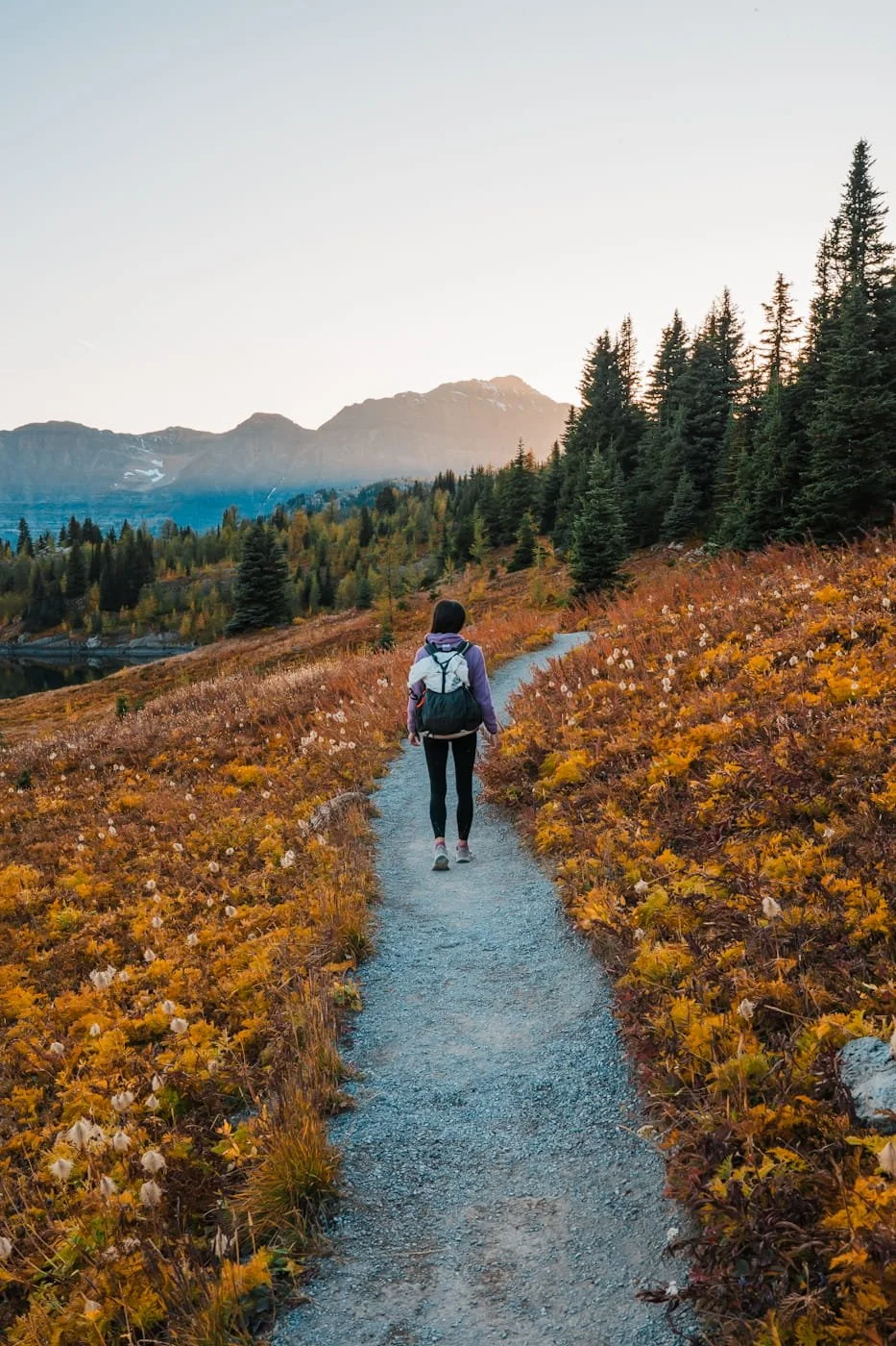 Girl hiking near Sunshine Mountain Resort during fall season and sunset