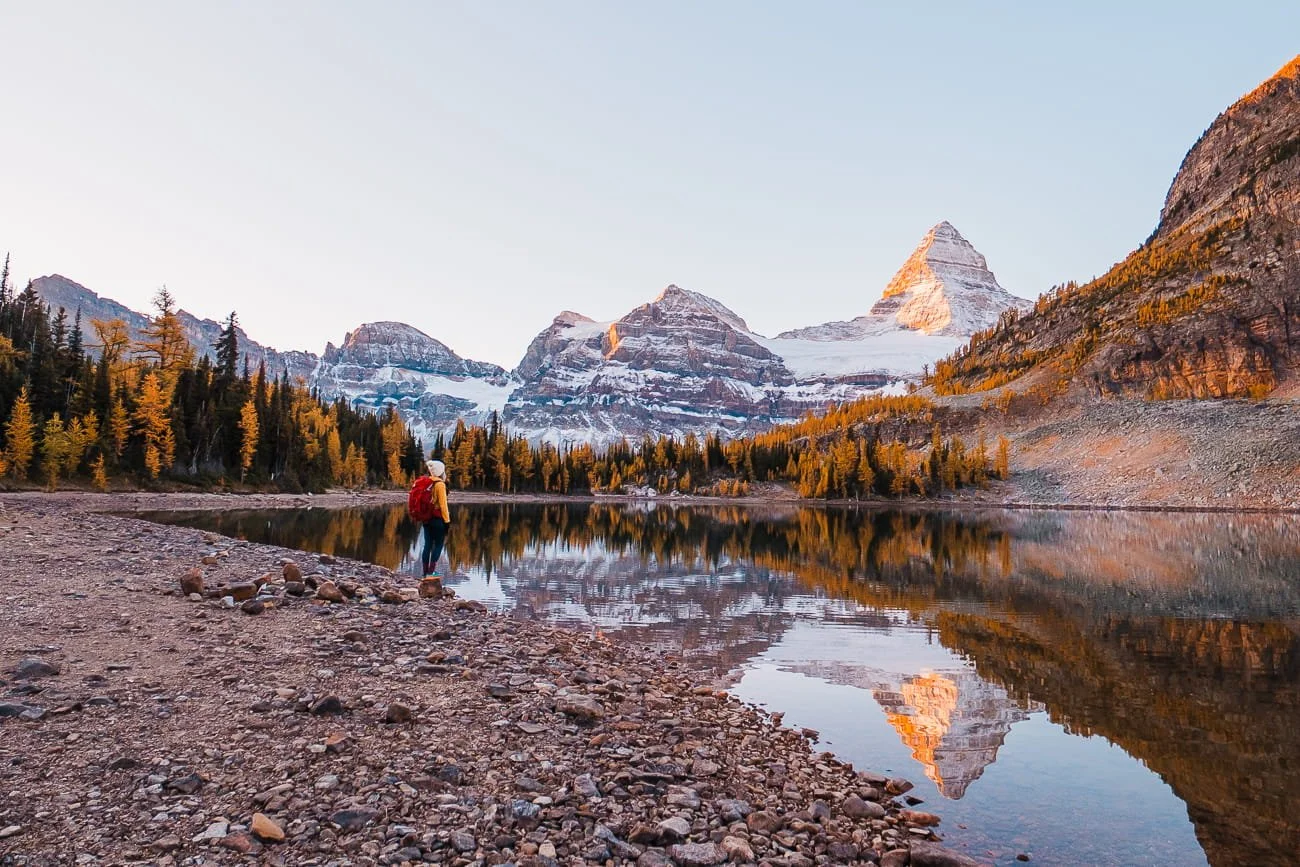 Girl standing on the shoreline of Sunburst Lake in Mount Assiniboine Provincial Park
