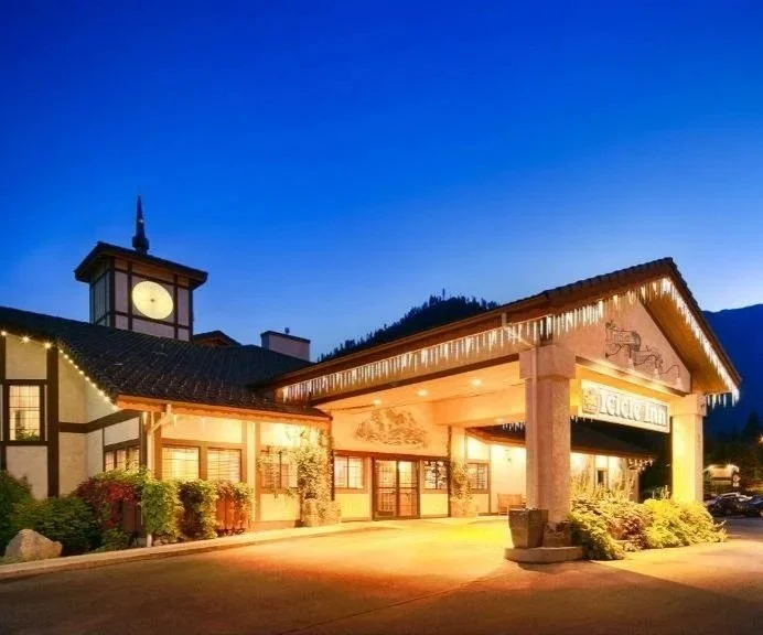 Looking at the front of the Icicle Village Resrt at night with christmas lights glowing