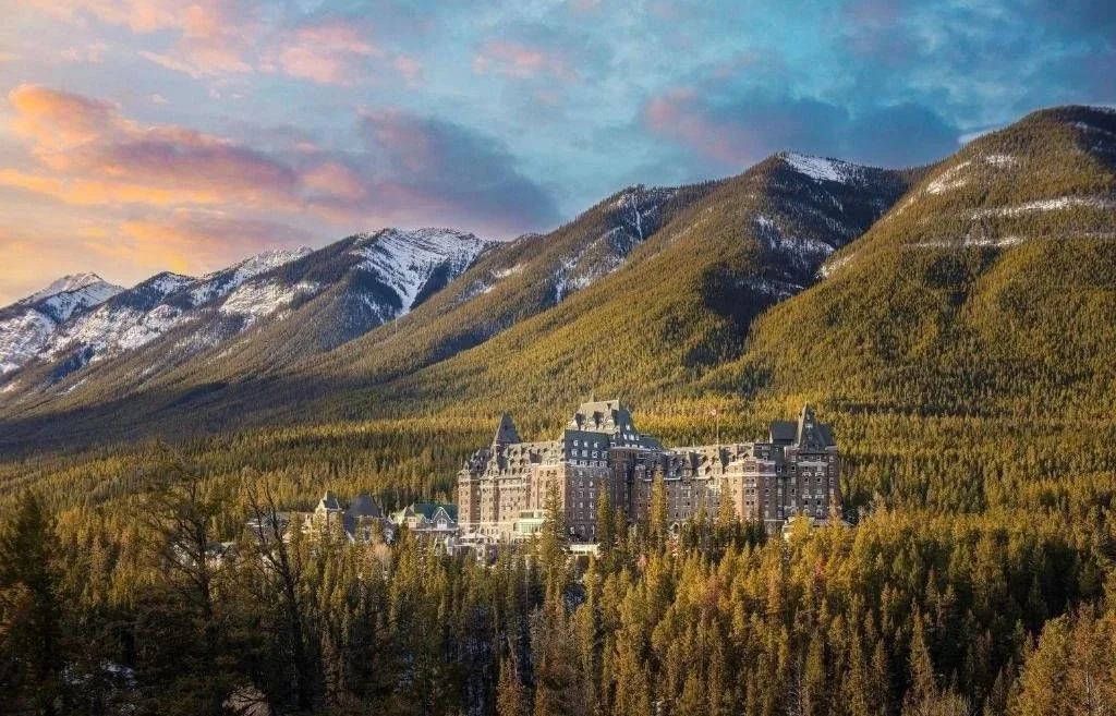 The Fairmont hotel in Banff, looking like a castle, perched in the mountains