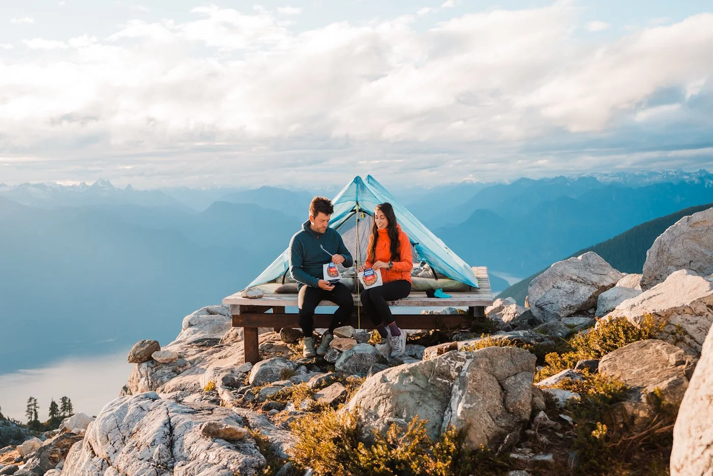 man and woman eating dehydrated dinners at Panorama Ridge camping area in Golden Ears Provincial Park