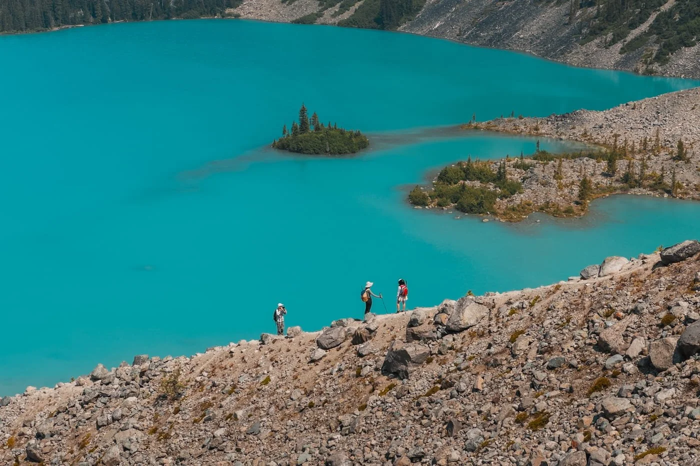 tiny hikers heading up a rocky ridge near Upper Joffre Lake
