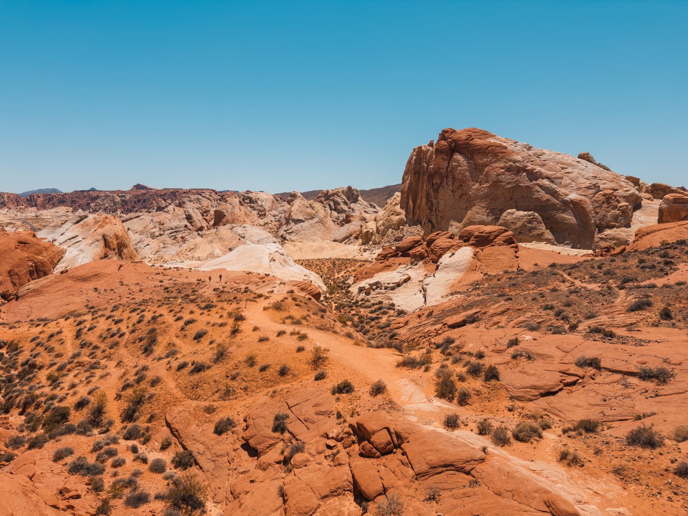 looking out at a trail running through a valley of sandstone formations